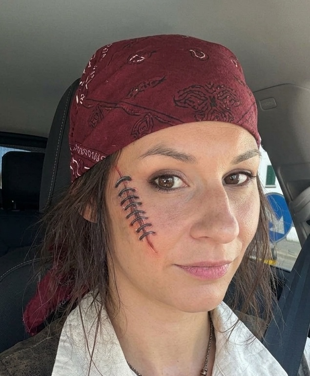 Adult woman with a painted stitched scar on her cheek